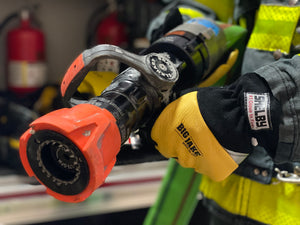 First Responder using Shelby Big Jake gloves to hold a fire hose nossel.